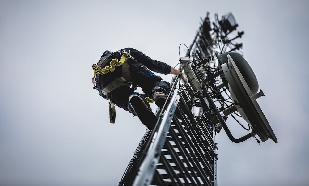 telecom-worker-climbing-antenna-tower-PEZMGB3